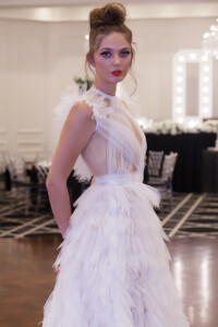 Size 10 to 12The dress features an illusion sheer bodice with a soft net train made from fine hand cut layers of tulle. Melbourne Wedding dress hire -Narla front